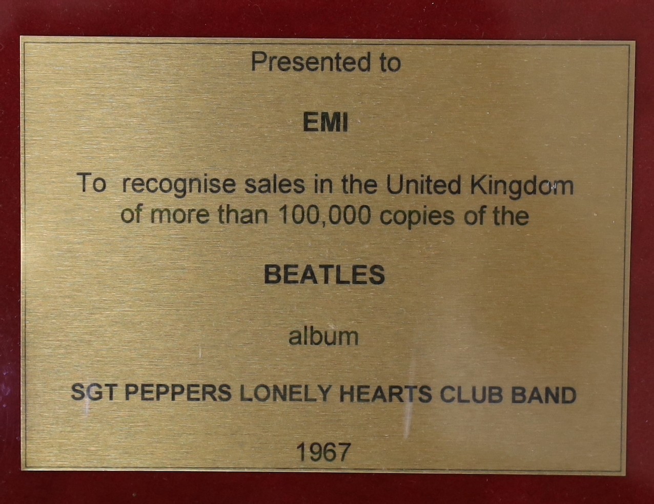Sgt. Peppers Lonely Hearts Club Band, a framed gold disc, presented to EMI to recognise sales in the United Kingdom, of more than 100,000 copies, frame 41 x 50cm